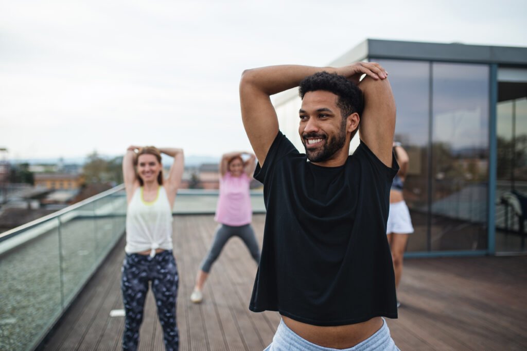 group of young people doing exercise in online dance class to improve Mental and Emotional Benefits of Dance​